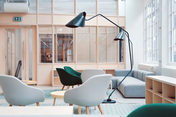 A furniture studio corner with lamps and accent chairs.