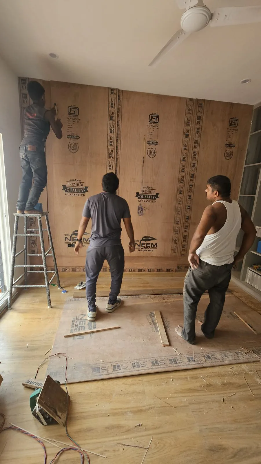 Factory-made joinery being fixed on site at the 1963 House.